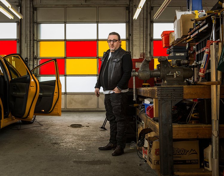 Gene Freidman in his garage in Long Island City in January. He's locked in litigation with Citibank, which is trying to seize many of his medallions.
