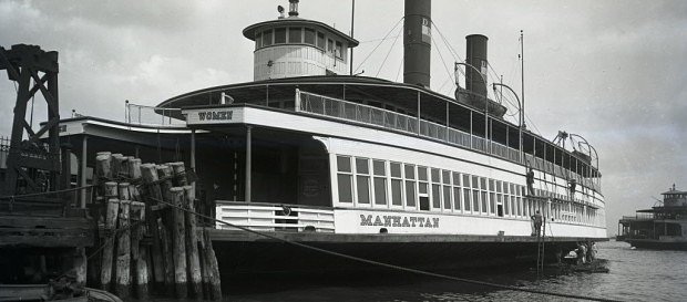 The ferry boat Manhattan tied up at the St. George terminal for painting, circa 1920.