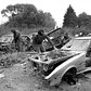 Police officers viewing abandoned cars on the Queens-Nassau border. June 5, 1985.