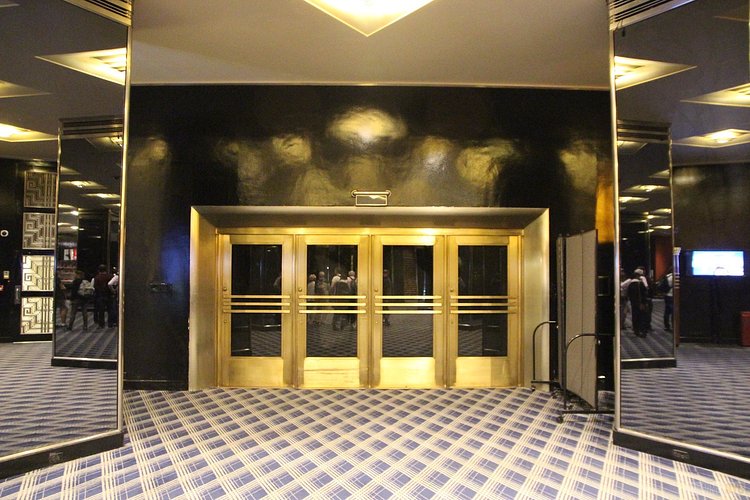 Rockefeller Plaza Subway Doors | Built in 1932, Radio City Music Hall is a prime example of art deco architectural style that has withstood the test of time. With tons of gold, reflective surfaces and geometric design, walking through the venue is a bit like stepping back in time. Most of the fixtures, furniture and ornamentation are original, and any replacements are exact replicas of how the theater looked 80 years ago.

Read more here: <a href="https://viewing.nyc/i-braved-a-walkthrough-of-radio-city-music-hall-meant-for-tourists/" rel="nofollow">viewing.nyc/i-braved-a-walkthrough-of-radio-city-music-ha...</a>