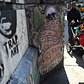 People walk by street graffti in New York on April 25, 2014.