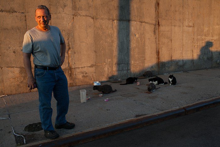Joe Tortora, 62, feeds a colony of feral cats under his care in Sunset Park, Brooklyn which totals nearly 40 cats. Joe is a former NY Sanitation employee who now spends his retirement savings on cat food and veterinarian bills to help the cats survive. As Joe says, "I can no longer afford to do this. The non-profits can get donations, I cannot. For people like me in the street everyday with the cats we are not getting any type of financial help, food alone is costing me $500 a month. The NY state legislation currently on the table could help with medical costs and that would be great...Bloomberg funded TNR programs to help stop the rat population and back then we had a grant to help pay for medical costs. Now all ~5000 colonies are on their own."