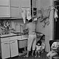 Rebecca with her children in their kitchen, 1982.
