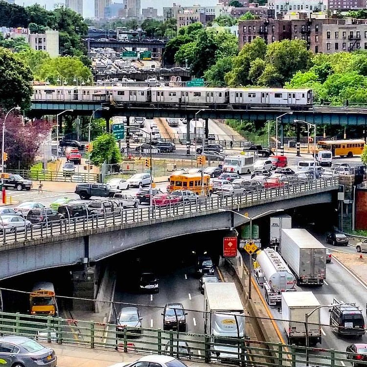 From the days before social distancing, a 4 train runs over the Cross Bronx Expressway