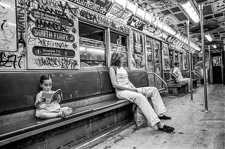 Little girl reads a book on the 1 train, summer of 1981