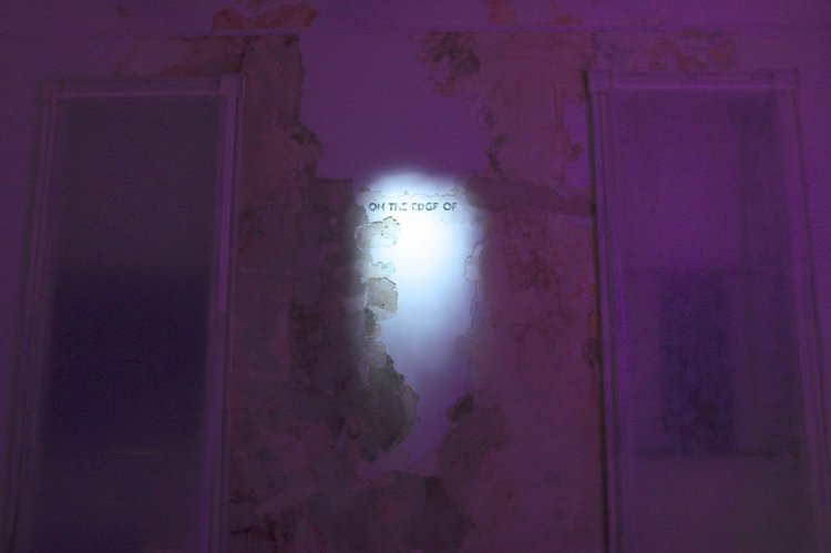 When artists from the Vanderbilt Collective began restoring a room inside Snug Harbor's Main Hall for their "Eutopia" exhibition, they came upon a partial sentence that had been painted and plastered over. It became a focal point of artist Taxiplasm's installation, "He To Himself For His Own."