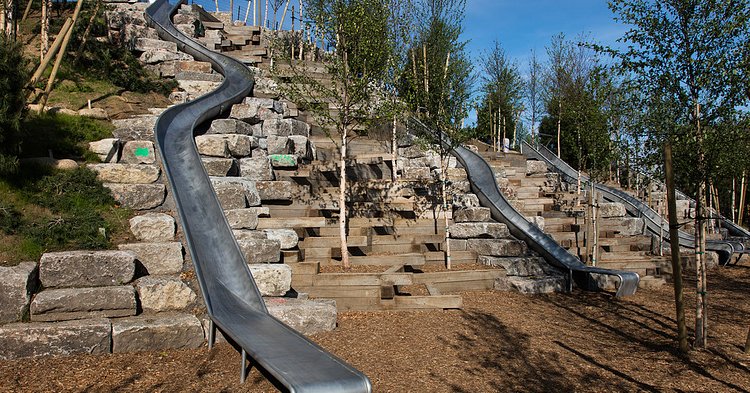 New slides on one of the island’s new hills, all of which will eventually be shaded by trees.