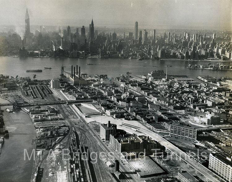 A view of Long Island City in 1940, with the tunnel in the middle of the image, and the Manhattan skyline in the background.