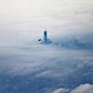 The newly constructed One World Trade Center building, dubbed "Freedom Tower," rises above the clouds on December 2, 2012, in an aerial photo taken from an airplane leaving New York's LaGuardia Airport. 