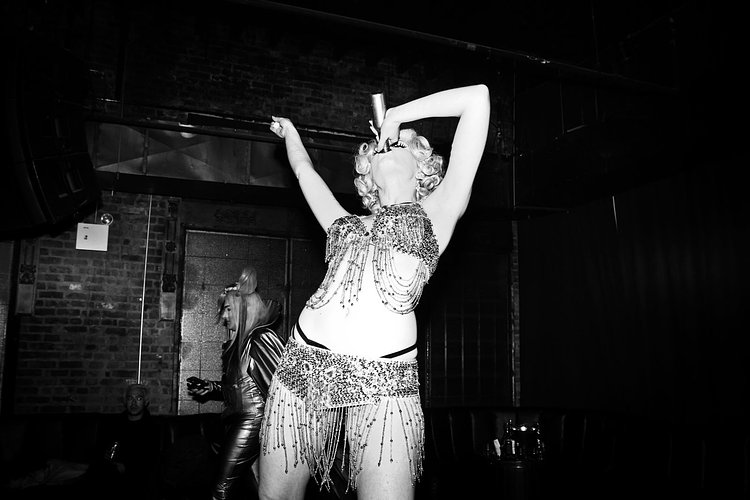 Burlesque performer Anna Evans regales the crowd with a coquettish rendition of Marilyn Monroe's "Diamonds Are a Girl's Best Friend"...