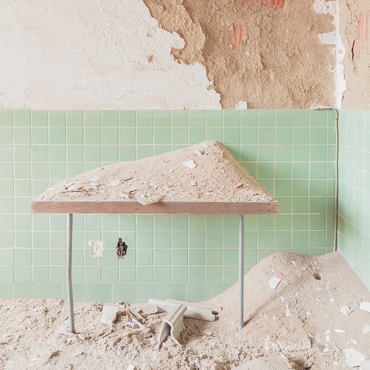 Drifts of plaster pile up on a table outside the darkroom.