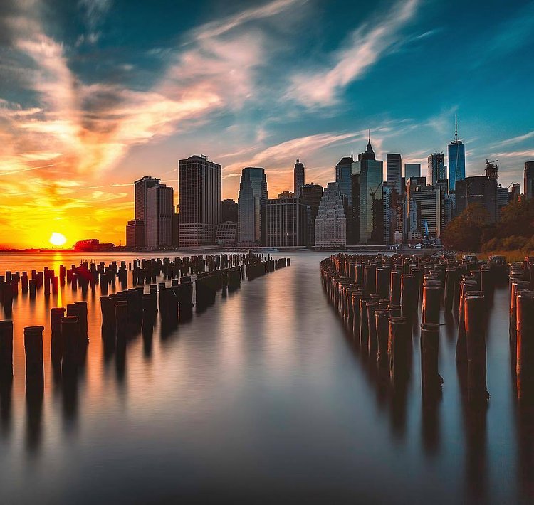 Sunset over Lower Manhattan skyline from Brooklyn Bridge Park