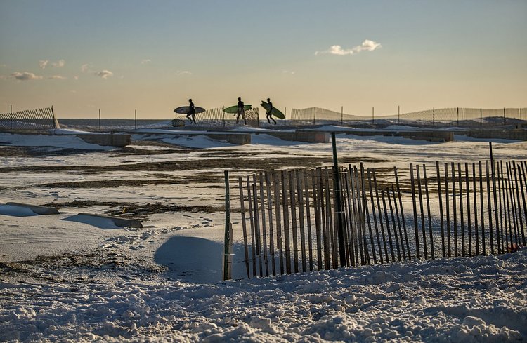 Winter surfers in New York City at Rockaway Beach