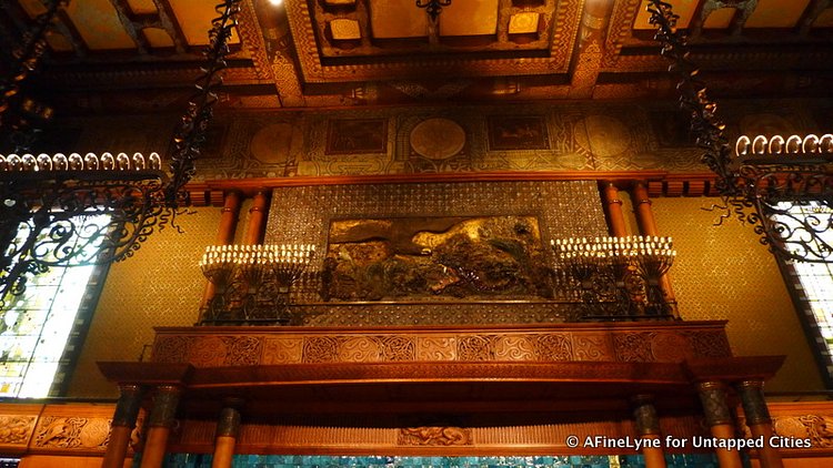 Above the fireplace is a Tiffany made glass and plaster mural depicting good vs evil.