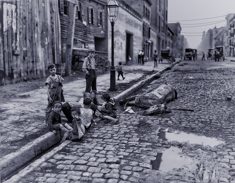 The Close of a Career in New York - 1905 | McDermott-Bunger Dairy Co. is painted on the building in the center of the photograph. As of 1903, this dairy company was
located at 527 West 125th Street.  There are 10 kids, all but one seem to be barefoot, playing in the street gutter and around puddles of raw sewage, all within in a few feet of a dead horse.  They seem completely unbothered and disinterested in it's existence.  They don't even seem slightly out-of-sorts, caught up in the moment of play and Joseph Byron's lense.

The Image was obtained from the Library of Congress.  The original glass plate can be seen via this link:  <a href="http://www.loc.gov/pictures/item/det1994000613/PP/resource/" rel="nofollow">www.loc.gov/pictures/item/det1994000613/PP/resource/</a>

This image restoration and enhancement is the product of Photoshop, Topaz, and Nik plugs, &amp; Akvis' Sketch renderer.