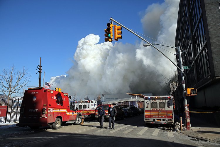 Firefighters continued pouring water on the remains of a 7-alarm fire in a warehouse on the Williamsburg waterfront