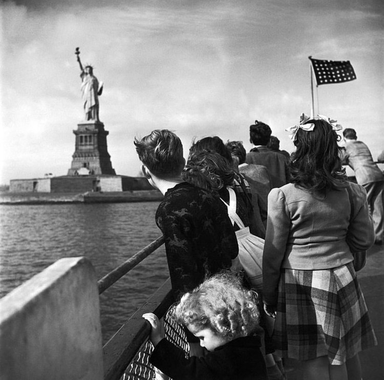 WWII refugee children viewing the Statue of Liberty as they enter the United States, 1946