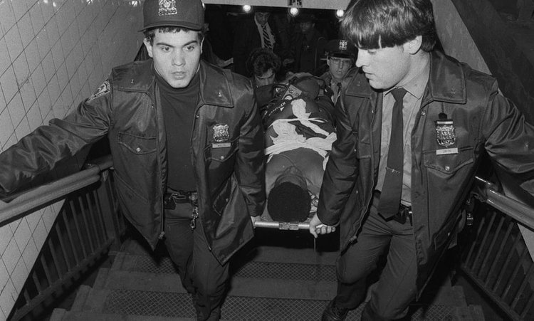 1980's: One of Bernhard Goetz's gunshot victims is carried out of the subway by paramedics. 