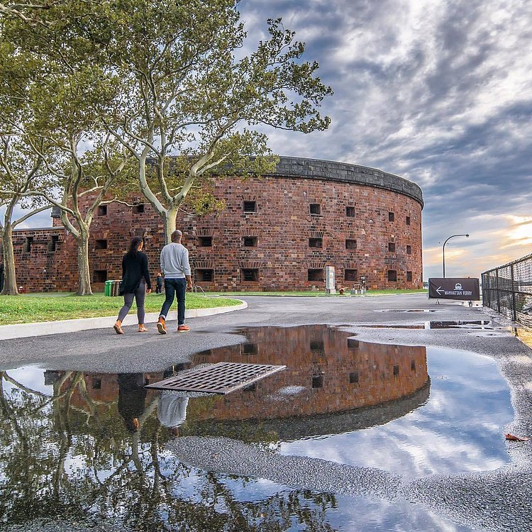 Castle Williams, a circular fortification of red sandstone on Governors Island. It is one of several forts built in the early 19th century to protect New York City from naval attack. Governors Island, New York City