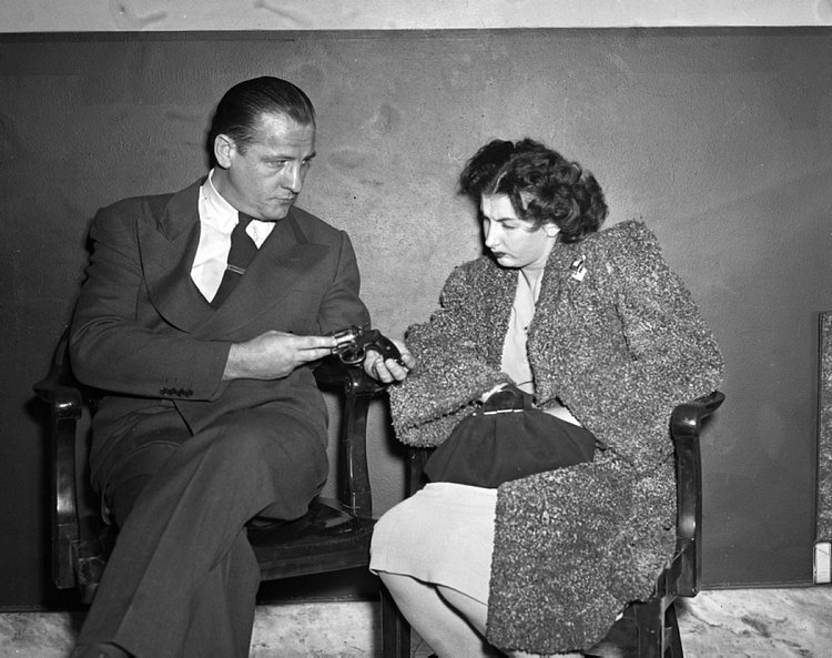 Mob Moll, 1947: Guns are apparently not a suitable purse accessory! Here, Lillian Stang, 23, is questioned by assistant DA James McGrattan after she was caught packing heat in 1947.