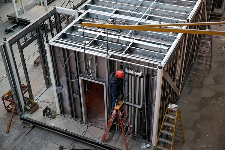 Plumbing is installed into open exterior walls. Open walls allow this type of work to be done at the same time as interior finish work.