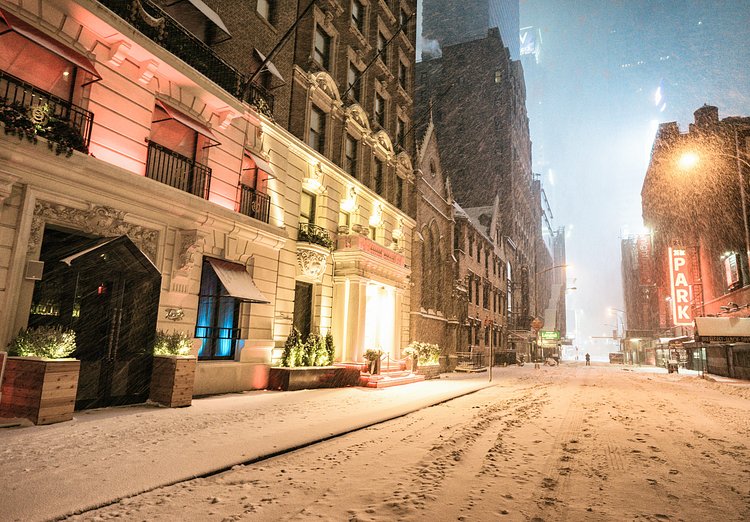 New York City - Snow - Winter Storm Juno - Near Times Square | Juno: The first snowstorm of 2015 in New York City.

---

(Note: My <a href="http://www.amazon.com/gp/product/1440339589/ref=as_li_tl?ie=UTF8&amp;camp=1789&amp;creative=9325&amp;creativeASIN=1440339589&amp;linkCode=as2&amp;tag=nyththle0e-20&amp;linkId=ER6GYT5FRYNMEPLF" rel="nofollow">New York photography book</a> released worldwide in stores/online recently and has photos similar to this  [full info below])

---

I have been photographing New York City during snowstorms at night for the past 5 years. When it comes to experiencing <a href="http://nythroughthelens.com/tagged/snow" rel="nofollow">New York City in the snow</a>, I relish the challenge. The more gusty, snowy, and brutal the storm, the more of a chance that I will be out in it traipsing around New York City with my cameras in tow.

When I heard that the MTA was suspending all transit service (and most vehicles) at 11 pm, I made the decision to take the train up to the Upper East Side prior to 11 pm to deposit myself up there with the intention of walking from the Upper East Side to Times Square and then walking the several miles back to the Lower East Side (whew!!).

The streets were eerily empty.

Emptier than they are usually at night during snowfall. Since there was a ban on all vehicles aside from snow plows and emergency services, there were practically no cars at all on the streets. Even taxis were banned from the streets!

I walked in the middle of avenues and streets that are usually teeming with cars.

There was an eerie sense of calm.

It was magical.


---

This is part of a post that I posted to my NYC photography blog. If you are curious enough to look at the photos there, here is the link to the post:

<a href="http://nythroughthelens.com/post/109291619025/new-york-city-snow-winter-storm-juno-i" rel="nofollow">New York City - Winter Storm Juno</a>


----

* As mentioned above - My New York City coffee table book that released in stores/online worldwide recently.

 Tons of information about my <a href="http://www.amazon.com/gp/product/1440339589/ref=as_li_tl?ie=UTF8&amp;camp=1789&amp;creative=9325&amp;creativeASIN=1440339589&amp;linkCode=as2&amp;tag=nyththle0e-20&amp;linkId=ER6GYT5FRYNMEPLF" rel="nofollow">New York photography book</a> with sample pages (including where to order and what stores are carrying it) here:

<a href="http://nythroughthelens.com/post/92873566010/ny-through-the-lens-the-book-i-am-super" rel="nofollow">NY Through The Lens: A New York Coffee Table Book</a>
---


View my New York City photography at my website <a href="http://nythroughthelens.com/" rel="nofollow">NY Through The Lens</a>.

View my Travel photography at my travel blog: <a href="http://travelinglens.me/" rel="nofollow">Traveling Lens</a>.

Interested in my work and have questions about PR and media? Check out my:

<a href="http://nythroughthelens.com/about" rel="nofollow">About Page</a> | <a href="http://nythroughthelens.com/PR" rel="nofollow">PR Page</a> | <a href="http://nythroughthelens.com/media" rel="nofollow">Media Page</a>