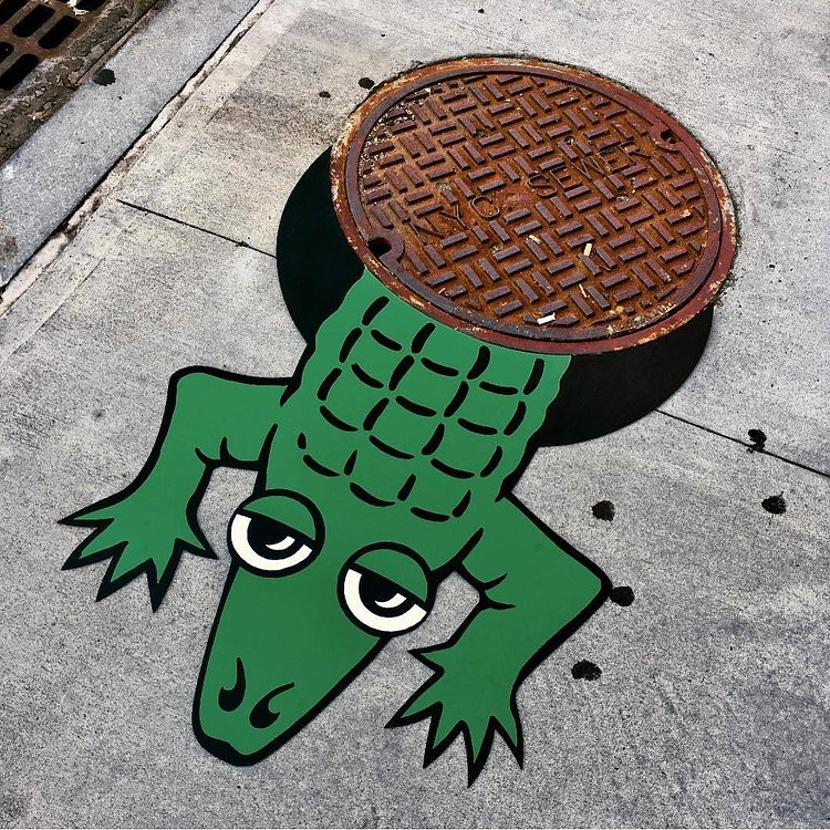ALLIGATOR SIGHTING DUMBO! 🐊 #alligator #nycsewer #brooklyn #newyorkcity #dumbo #streetart #nyc #sewer #🐊 #streetartbrooklyn #tombobnyc #streetartnyc #tombob #publicart #cartoon 🐊#manhole #manholecover #👀