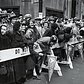A crowd waits by along the St. Patrick's Day Parade route on 5th Avenue in 1951 New York.