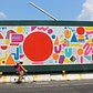 Lead artist Mike Perry's mural shows off his bold, bright style, which usually includes a lot of colorful squiggles.