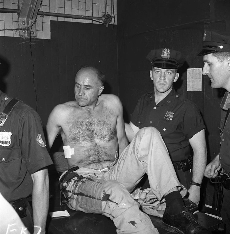 1960's: Navigating the underground tunnels constituting New York's subway system could be dangerous business. Here, a man is treated in Grand Central Station after being stabbed on the subway.