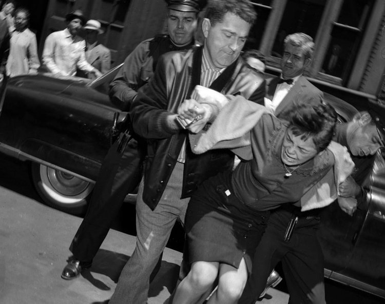Mob Moll, 1959: They start them young! While most people consider the mob to be made up of a bunch of men, that acutally isn't the case. Here, 15-year-old moll Carmen Martinez doesn't go down without a fight as she is hauled off by police to Felony Court for the murder of 17-year-old Raul Banuchi.