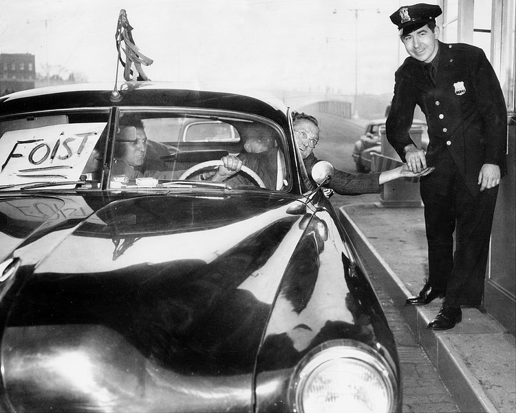 May 25, 1950: Cop grins broadly as driver of one of the first cars to enter the Brooklyn end of the Brooklyn Battery Tunnel hands him his ticket.