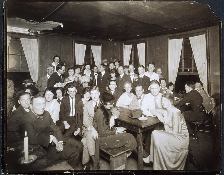 Group portrait, indoors, of people gathered at the Garrett Coffee House, circa 1912-1917; photograph by Jessie Tarbox Beals.