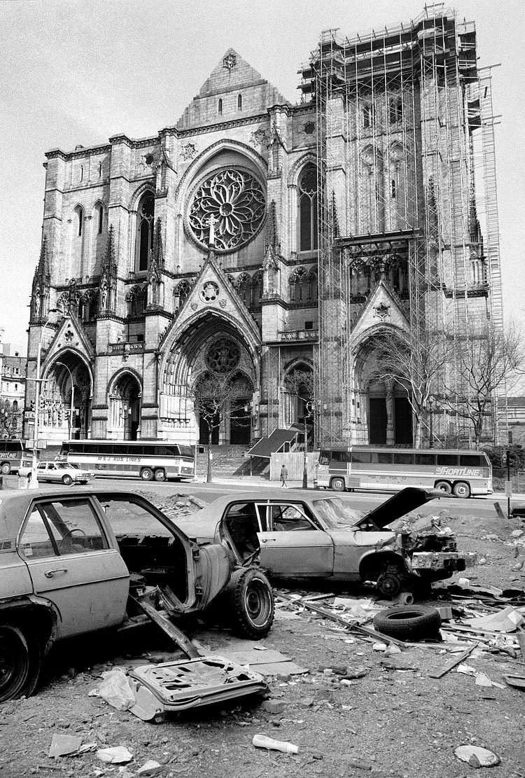 Abandoned cars littered Amsterdam Avenue and 112th Street, across the street from the Cathedral of St. John the Divine. April 10, 1985.