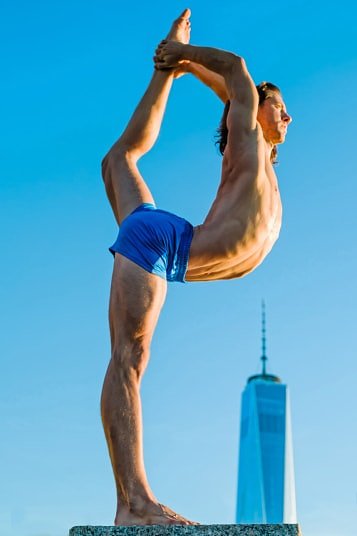 Performing yoga with the One World Trade Center in New York as a backdrop