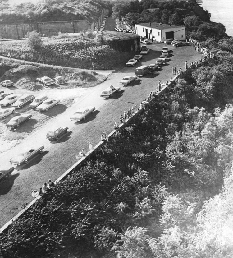 Spectators line up among the shore in Fort Wadsworth to get a better view of the first-day festivities of "Son of Op Sail." Civilian spectators were allowed into the fort to get a good vantage point for the show. Photo circa 1977.