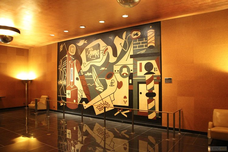 Men's Room Mural | Built in 1932, Radio City Music Hall is a prime example of art deco architectural style that has withstood the test of time. With tons of gold, reflective surfaces and geometric design, walking through the venue is a bit like stepping back in time. Most of the fixtures, furniture and ornamentation are original, and any replacements are exact replicas of how the theater looked 80 years ago.

Read more here: <a href="https://viewing.nyc/i-braved-a-walkthrough-of-radio-city-music-hall-meant-for-tourists/" rel="nofollow">viewing.nyc/i-braved-a-walkthrough-of-radio-city-music-ha...</a>