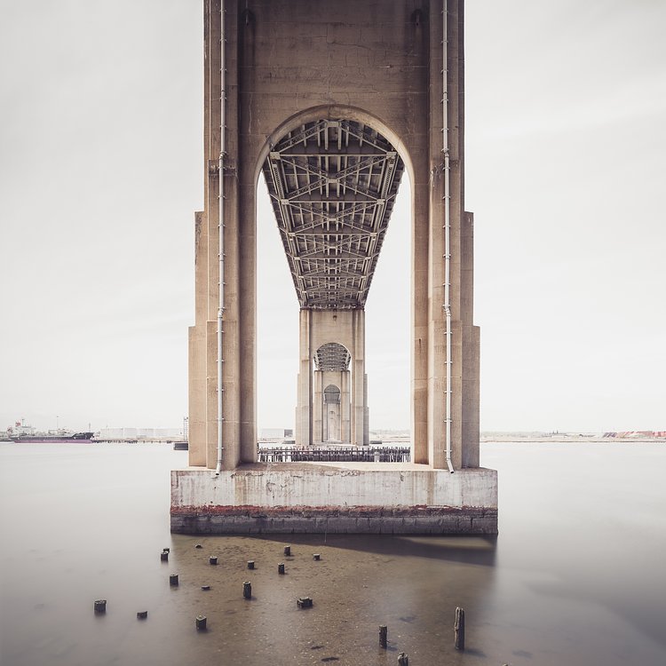 Rotted pilings beneath Outerbridge Crossing, with views of Perth Amboy, NJ.