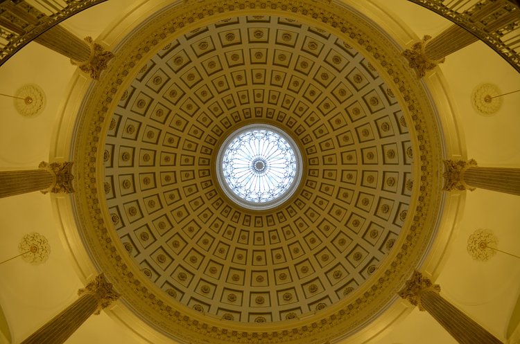 Before heading up the stairs to the second floor, take a look up to see the rotunda's dome.