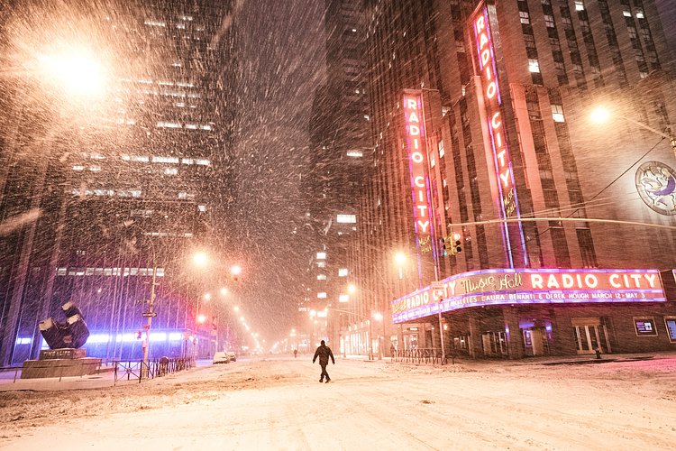 New York City - Snow - Winter Storm Juno - Radio City | Juno: The first snowstorm of 2015 in New York City.

---

(Note: My <a href="http://www.amazon.com/gp/product/1440339589/ref=as_li_tl?ie=UTF8&amp;camp=1789&amp;creative=9325&amp;creativeASIN=1440339589&amp;linkCode=as2&amp;tag=nyththle0e-20&amp;linkId=ER6GYT5FRYNMEPLF" rel="nofollow">New York photography book</a> released worldwide in stores/online recently and has photos similar to this  [full info below])

---

I have been photographing New York City during snowstorms at night for the past 5 years. When it comes to experiencing <a href="http://nythroughthelens.com/tagged/snow" rel="nofollow">New York City in the snow</a>, I relish the challenge. The more gusty, snowy, and brutal the storm, the more of a chance that I will be out in it traipsing around New York City with my cameras in tow.

When I heard that the MTA was suspending all transit service (and most vehicles) at 11 pm, I made the decision to take the train up to the Upper East Side prior to 11 pm to deposit myself up there with the intention of walking from the Upper East Side to Times Square and then walking the several miles back to the Lower East Side (whew!!).

The streets were eerily empty.

Emptier than they are usually at night during snowfall. Since there was a ban on all vehicles aside from snow plows and emergency services, there were practically no cars at all on the streets. Even taxis were banned from the streets!

I walked in the middle of avenues and streets that are usually teeming with cars.

There was an eerie sense of calm.

It was magical.


---

This is part of a post that I posted to my NYC photography blog. If you are curious enough to look at the photos there, here is the link to the post:

<a href="http://nythroughthelens.com/post/109291619025/new-york-city-snow-winter-storm-juno-i" rel="nofollow">New York City - Winter Storm Juno</a>


----

* As mentioned above - My New York City coffee table book that released in stores/online worldwide recently.

 Tons of information about my <a href="http://www.amazon.com/gp/product/1440339589/ref=as_li_tl?ie=UTF8&amp;camp=1789&amp;creative=9325&amp;creativeASIN=1440339589&amp;linkCode=as2&amp;tag=nyththle0e-20&amp;linkId=ER6GYT5FRYNMEPLF" rel="nofollow">New York photography book</a> with sample pages (including where to order and what stores are carrying it) here:

<a href="http://nythroughthelens.com/post/92873566010/ny-through-the-lens-the-book-i-am-super" rel="nofollow">NY Through The Lens: A New York Coffee Table Book</a>
---


View my New York City photography at my website <a href="http://nythroughthelens.com/" rel="nofollow">NY Through The Lens</a>.

View my Travel photography at my travel blog: <a href="http://travelinglens.me/" rel="nofollow">Traveling Lens</a>.

Interested in my work and have questions about PR and media? Check out my:

<a href="http://nythroughthelens.com/about" rel="nofollow">About Page</a> | <a href="http://nythroughthelens.com/PR" rel="nofollow">PR Page</a> | <a href="http://nythroughthelens.com/media" rel="nofollow">Media Page</a>
