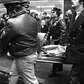 1970's: A body is covered and carried away after a patrolman was killed during a shooting at the 8th St. subway station in 1975.