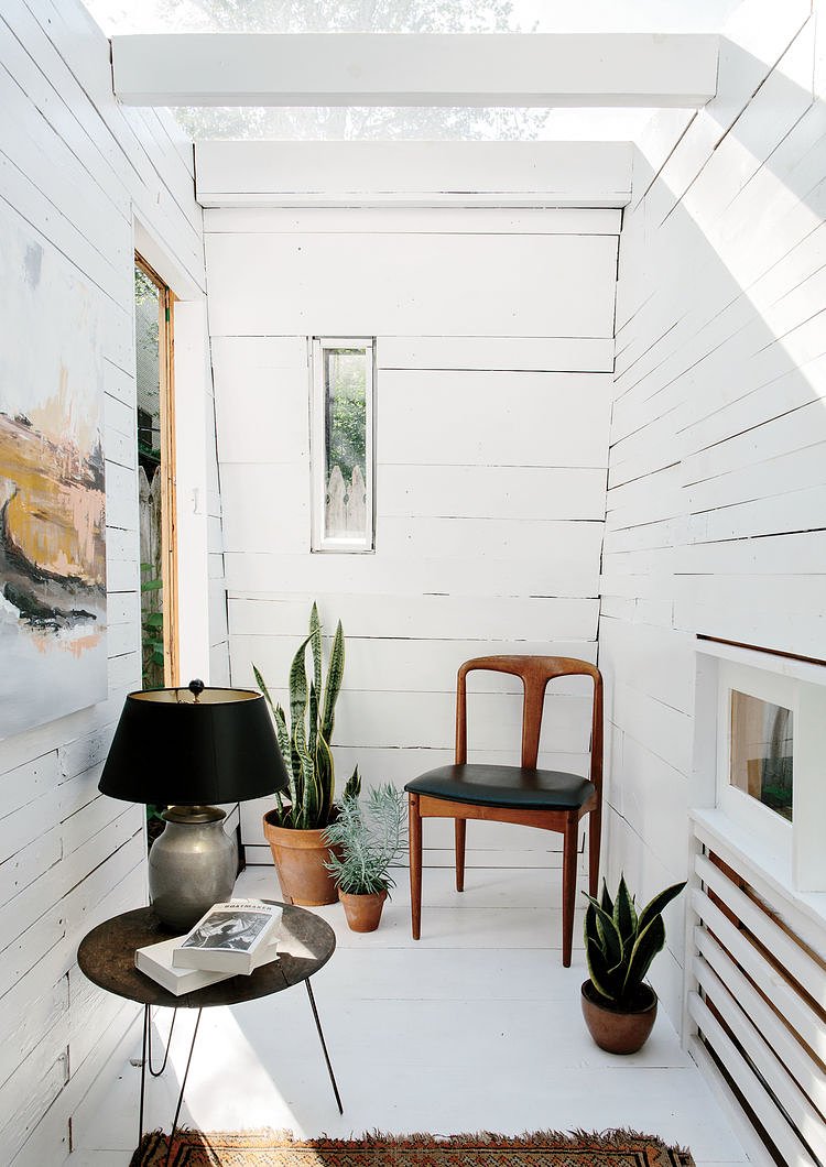 The interior features fence pickets from Hunt’s parents’ house and a rotating selection of furniture from his apartment.  