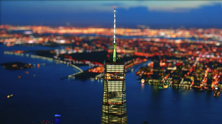 One World Trade Center's soaring spire is the focus of the colourful image above as the lights of Jersey City illuminate the background. 