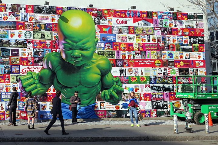 The artist and his mural — to be further enhanced — featuring his iconic Temper Tot and his take on the American flag