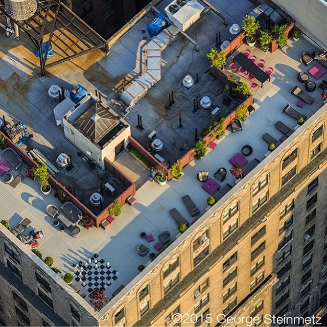 Photograph by George Steinmetz @geosteinmetz / @thephotosociety  Chess Manhattan style … on the rooftop at #TheGreystone, 2454 Broadway, in #NewYorkCity. The building was originally constructed in 1923 as a stately hotel and renovated into luxury apartments.