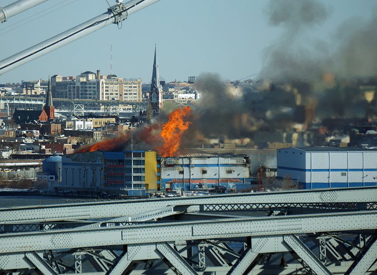 Firefighters continued pouring water on the remains of a 7-alarm fire in a warehouse on the Williamsburg waterfront