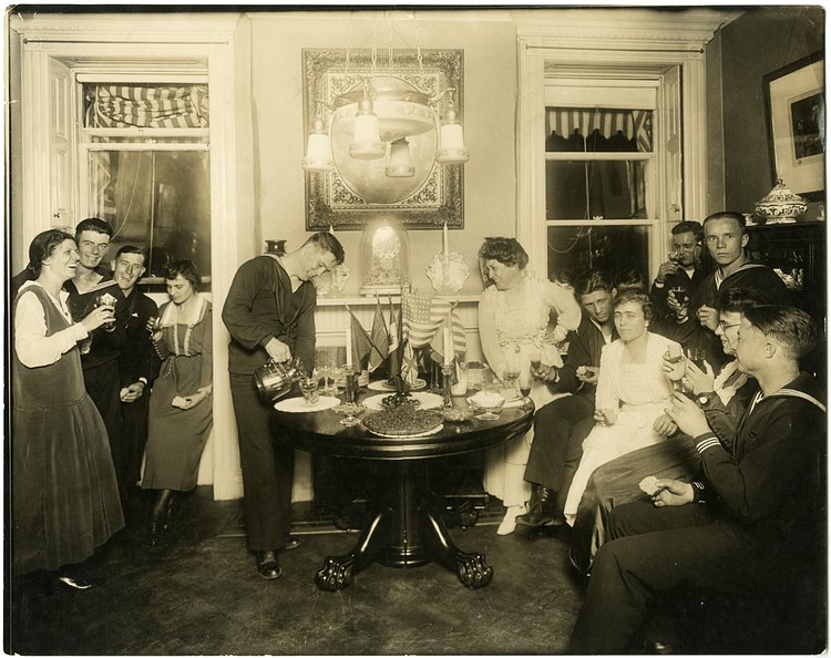 Alice Foote MacDougal entertaining a group of sailors in her small apartment, circa 1917-1918; photograph by Jessie Tarbox Beals.