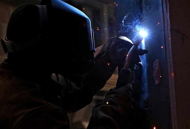 Welding the window frame to the apartment module.