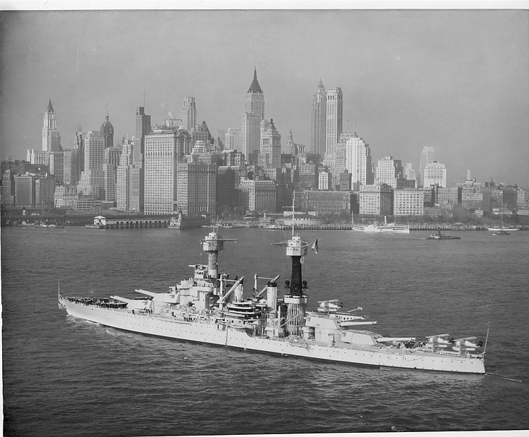 The battleship Colorado (BB 45) steams off New York City with the city's historic skyline serving as a backdrop.