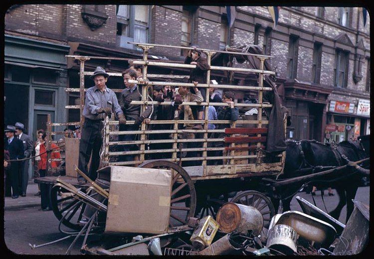 The men pictured here are collecting wartime salvage left outside on the streets of the Lower East Side.